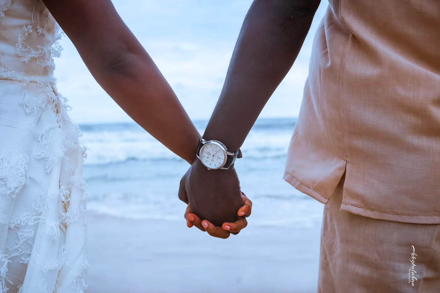 Hannah and Samuel holding hands by the sea as their two paths became one